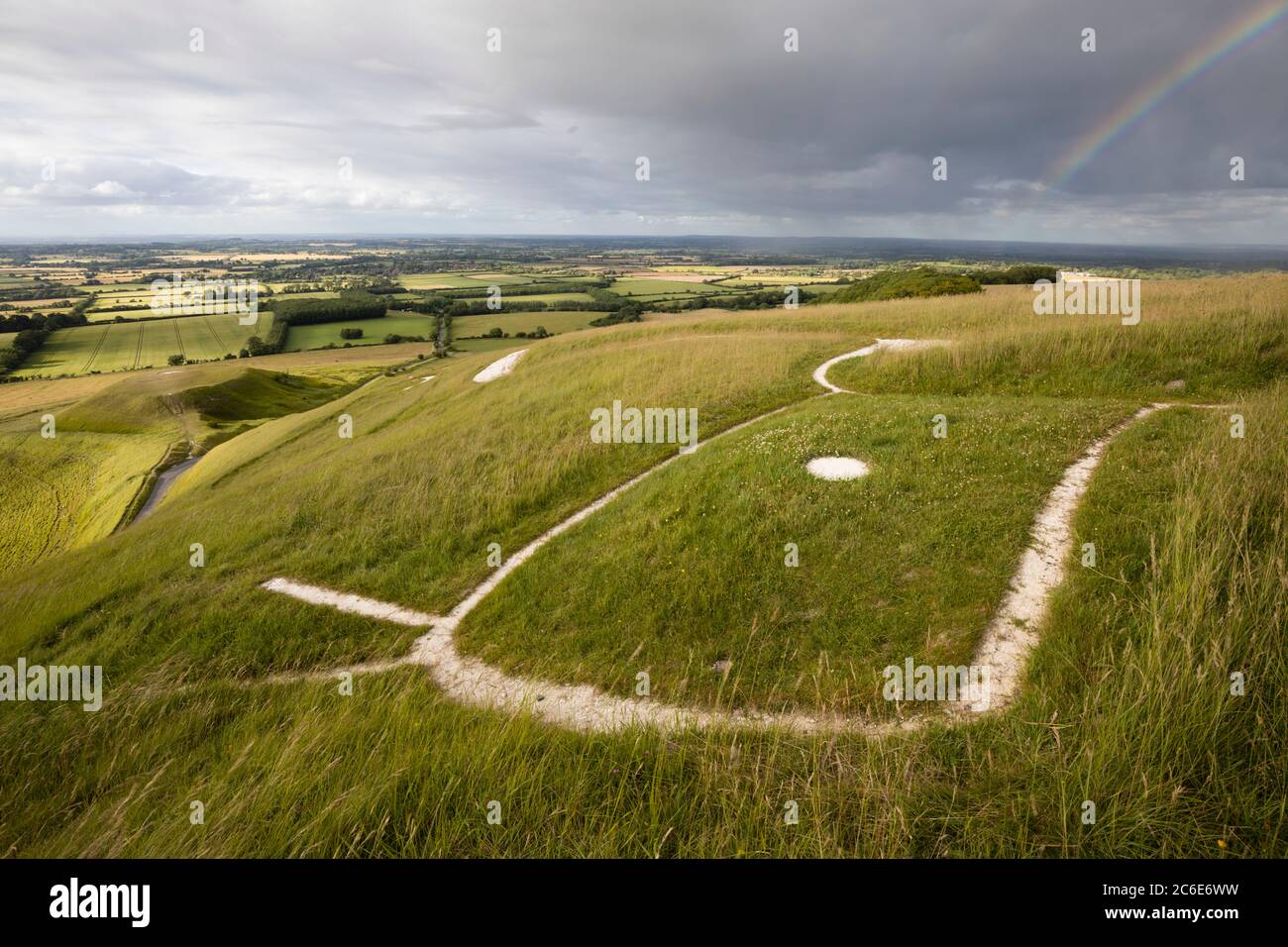 The prehistoric White Horse carving and Dragon Hill with Vale of White Horse with rainbow, Uffington, Oxfordshire, England, United Kingdom, Europe Stock Photo