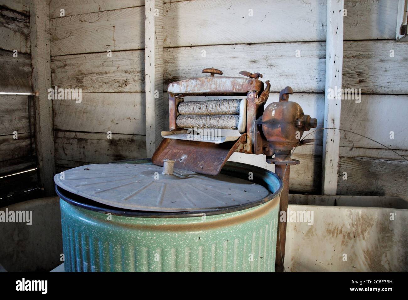 Old fashion wringer washing machine which is cast off into the garage Stock Photo