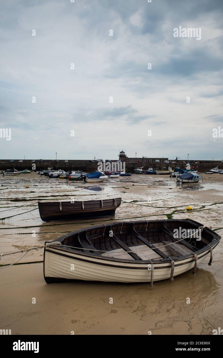 View of boats in St. Ives beach at low tide in Cornwall in England Stock Photo