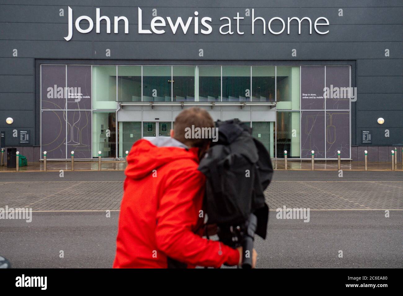 A member of the media films outside the John Lewis At Home store in Tamworth, which is due to close as John Lewis said it will shut two full-size department stores in Birmingham and Watford, four At Home shops in Croydon, Newbury, Swindon and Tamworth, as well as two travel hub outlets at Heathrow and St Pancras. Stock Photo