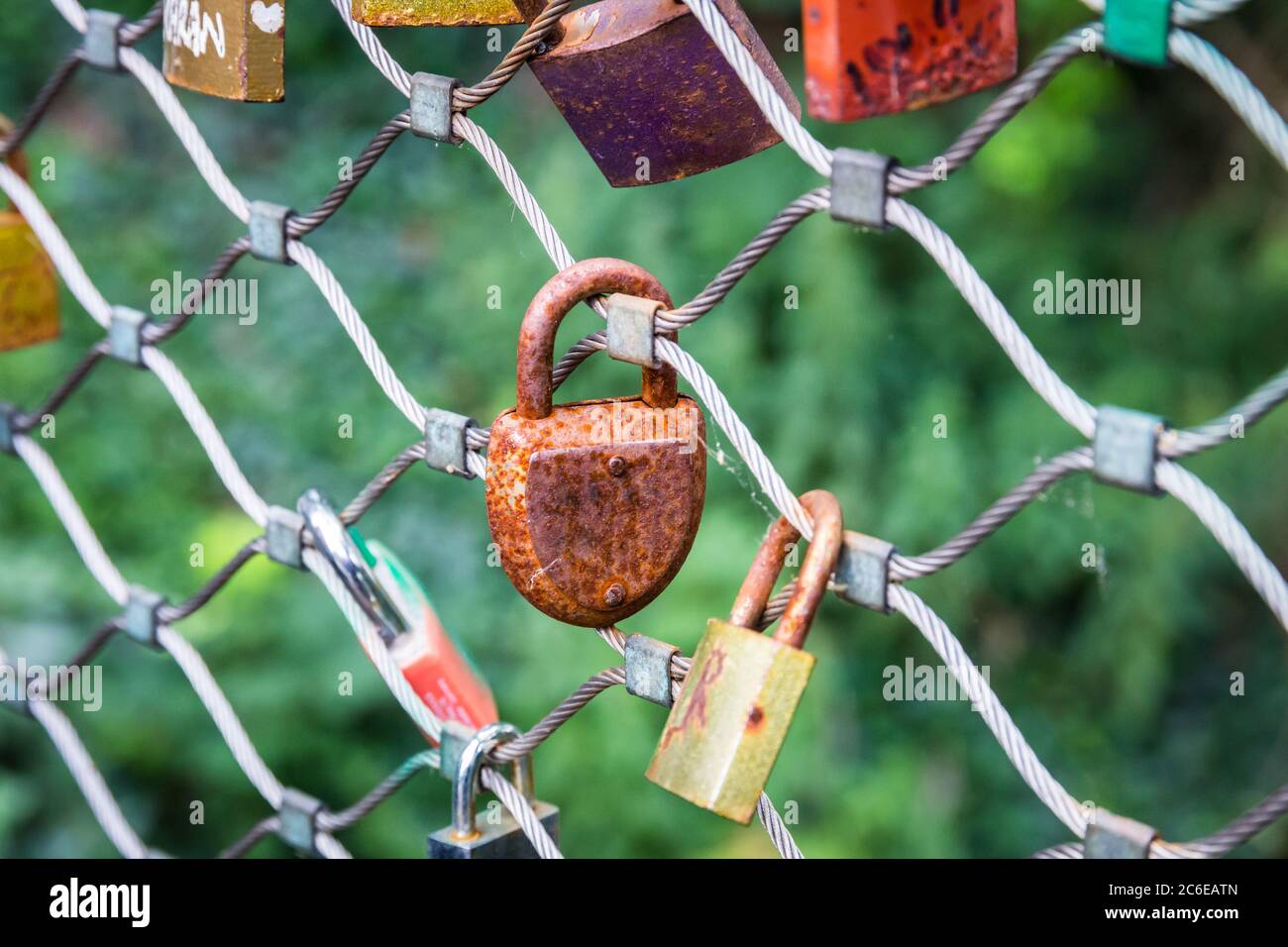 You can see an old rusty lock hanging in the middle of the picture on a ...