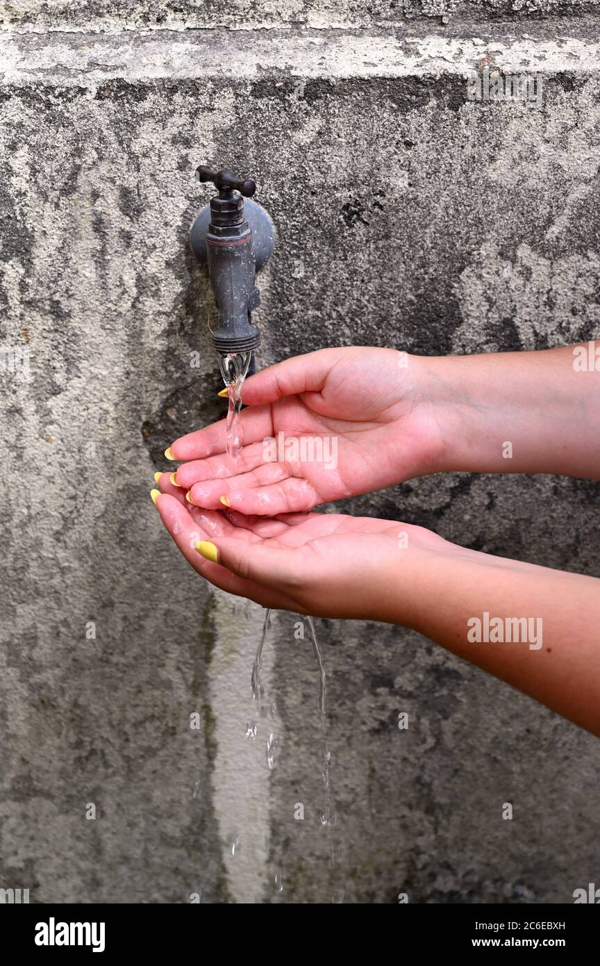 Public fountain in the village. Covid-19 is dangerous and wahsing hands is a health protection Stock Photo