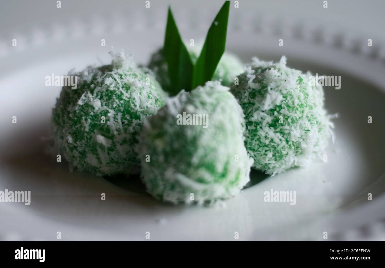 Klepon. Traditional pandanus rice balls made from glutinous flour and grated coconut with palm sugar filling. Indonesian traditional food. Stock Photo