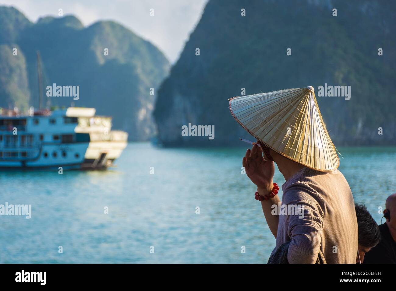 HA LONG BAY, VIETNAM, JANUARY 6 2020: Vietnamese man smoking with a ...