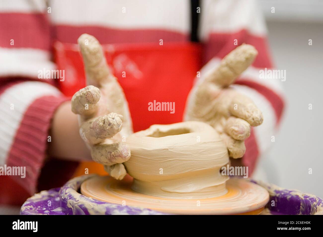 Child hands working on pottery wheel toy Stock Photo - Alamy