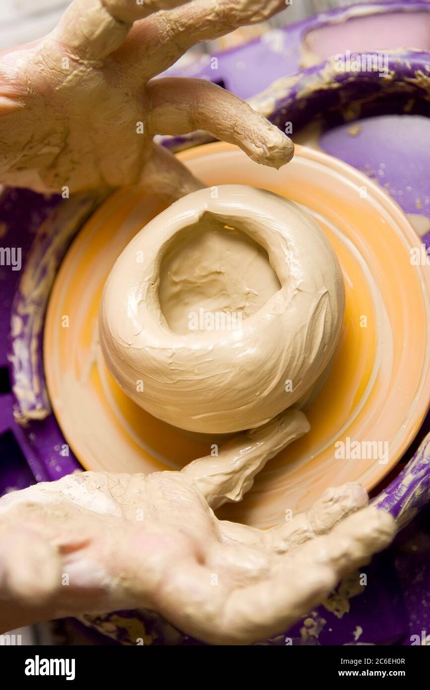 Child hands working on pottery wheel toy Stock Photo - Alamy