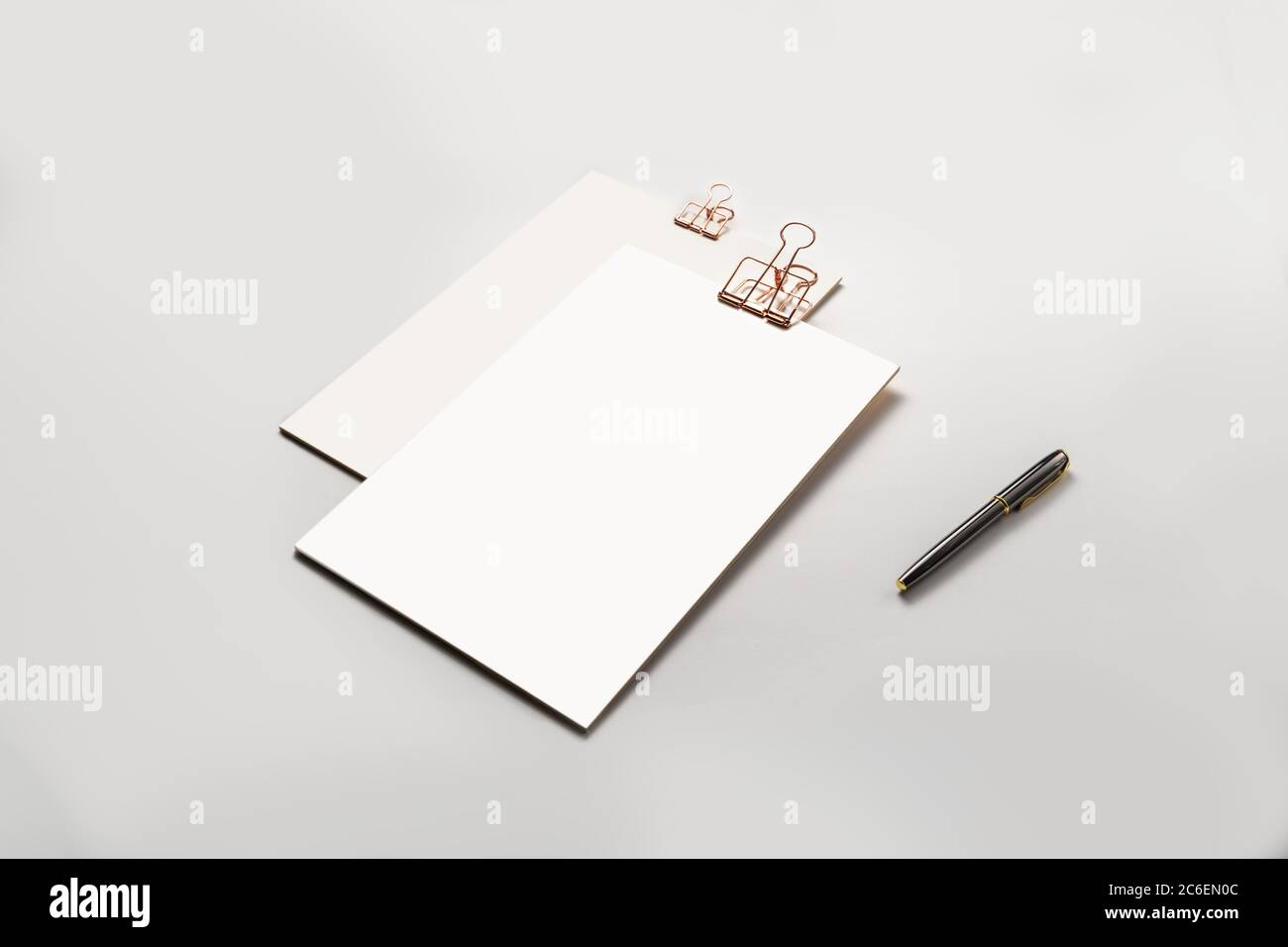 Clipboard with golden clip, blank sheets of paper and pen on white background. Template for branding identity. minimal mock up template concept. Stock Photo
