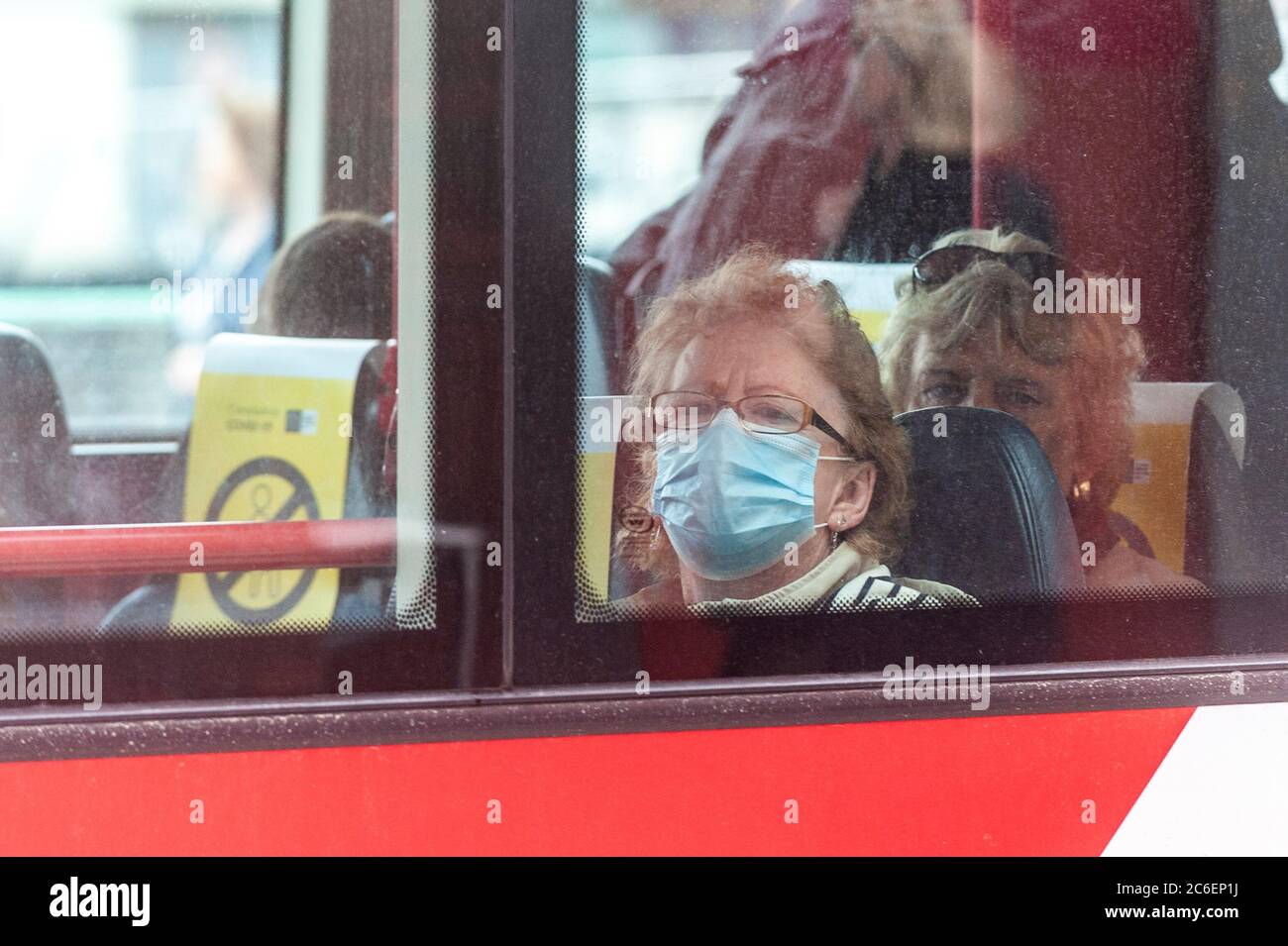 Cork, Ireland. 9th July, 2020. A woman wears a face mask on a Bus
