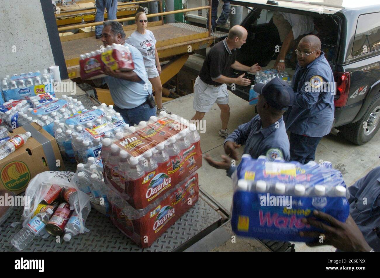 Austin, Texas September 3, 2005: Refugees from Hurricane Katrina continue to pour into Texas shelters including the Austin Convention Center, which is expecting over 5,000 people in the next three days.  City of Austin employees unload bottled water for refugees. ©Bob Daemmrich/ Stock Photo