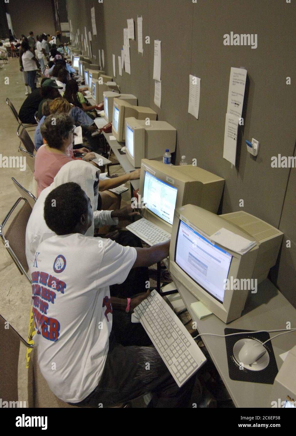 Austin, Texas USA, September 5, 2005: Dozens of internet-connected computers are lined up and being used by Hurricane Katrina refugees at the Austin Convention Center for connections to family and friends due to last week's weather disaster on the Gulf Coast.  ©Bob Daemmrich Stock Photo