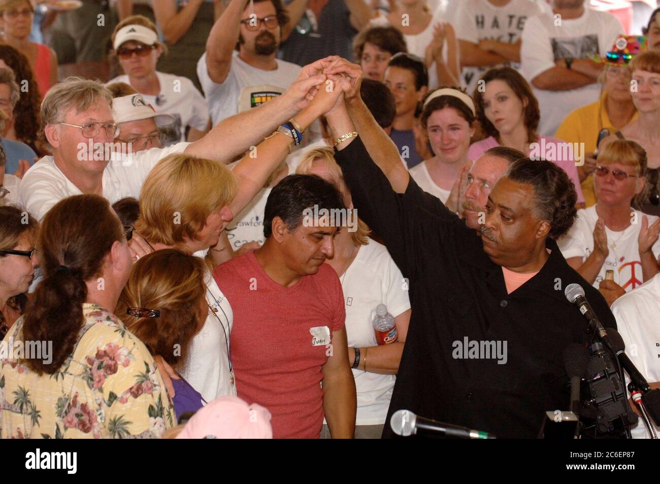 Crawford, Texas August 28, 2005: Anti-war activist Cindy Sheehan (left) and others clasp hands with Rev. Al Sharpton as Sharpton conducts a church service at Camp Casey II near U.S. President George W. Bush's Texas ranch.  Sheehan, whose son Casey died in action in Iraq in 2004, has organized a series of protests near the Bushes' Texas ranch during the president's summer vacation there.  ©Bob Daemmrich Stock Photo