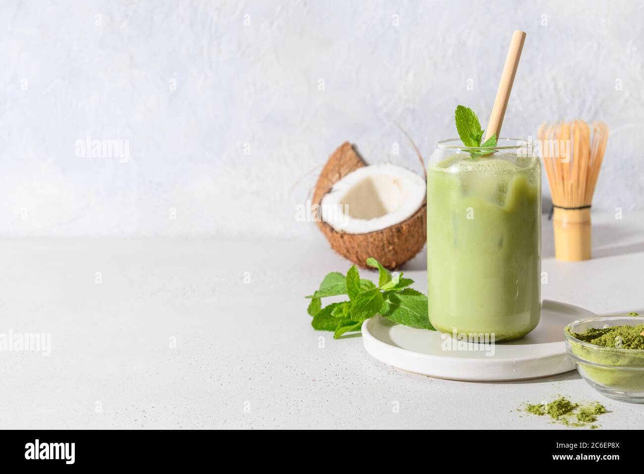 Iced latte green matcha tea with coconut milk garnish mint on white