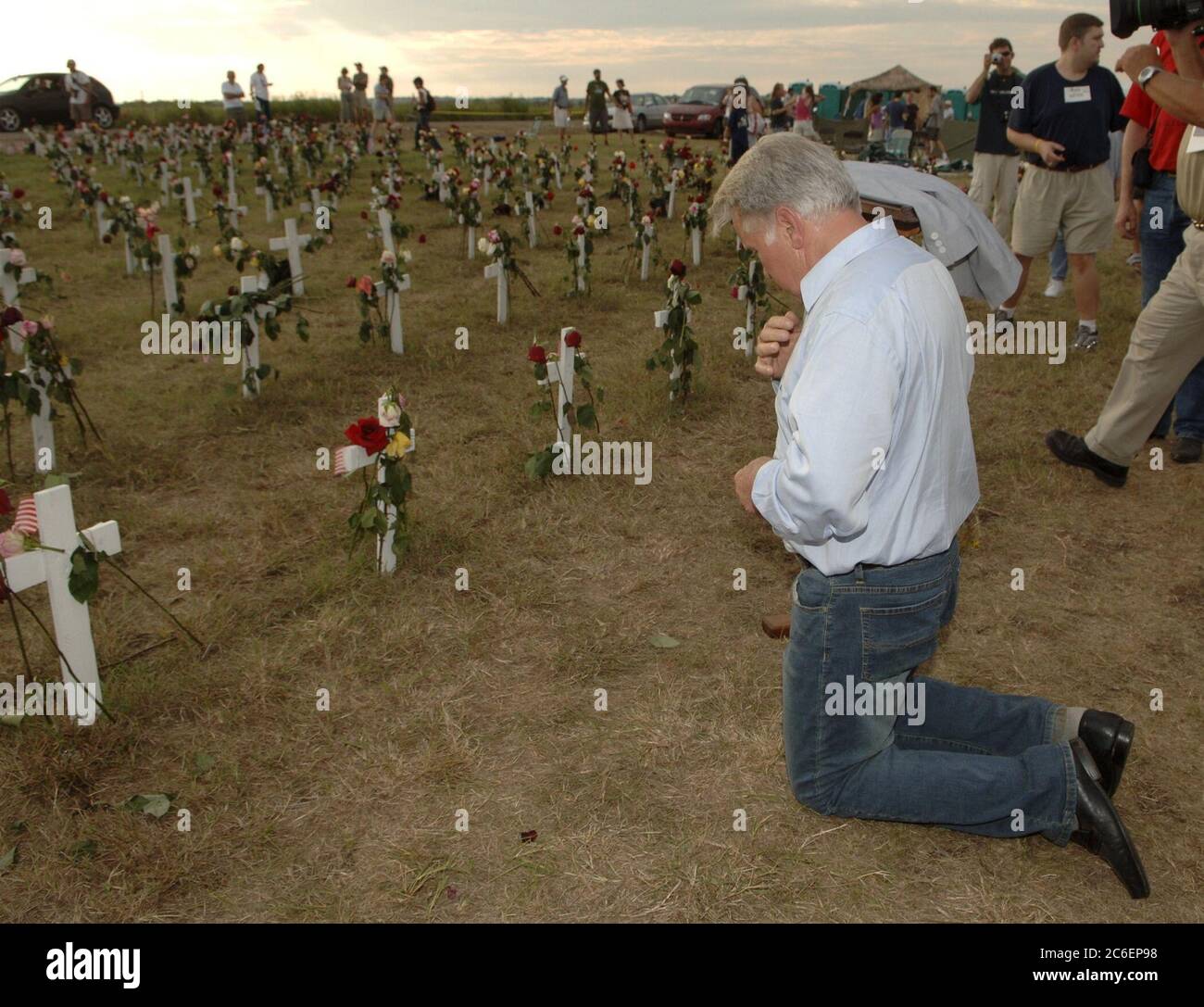 Crawford, Texas August 28, 2005:  Anti-war activist and actor Martin Sheen kneels to pray at crosses at Camp Casey II near President Bush's ranch. Photo by Bob Daemmrich Stock Photo
