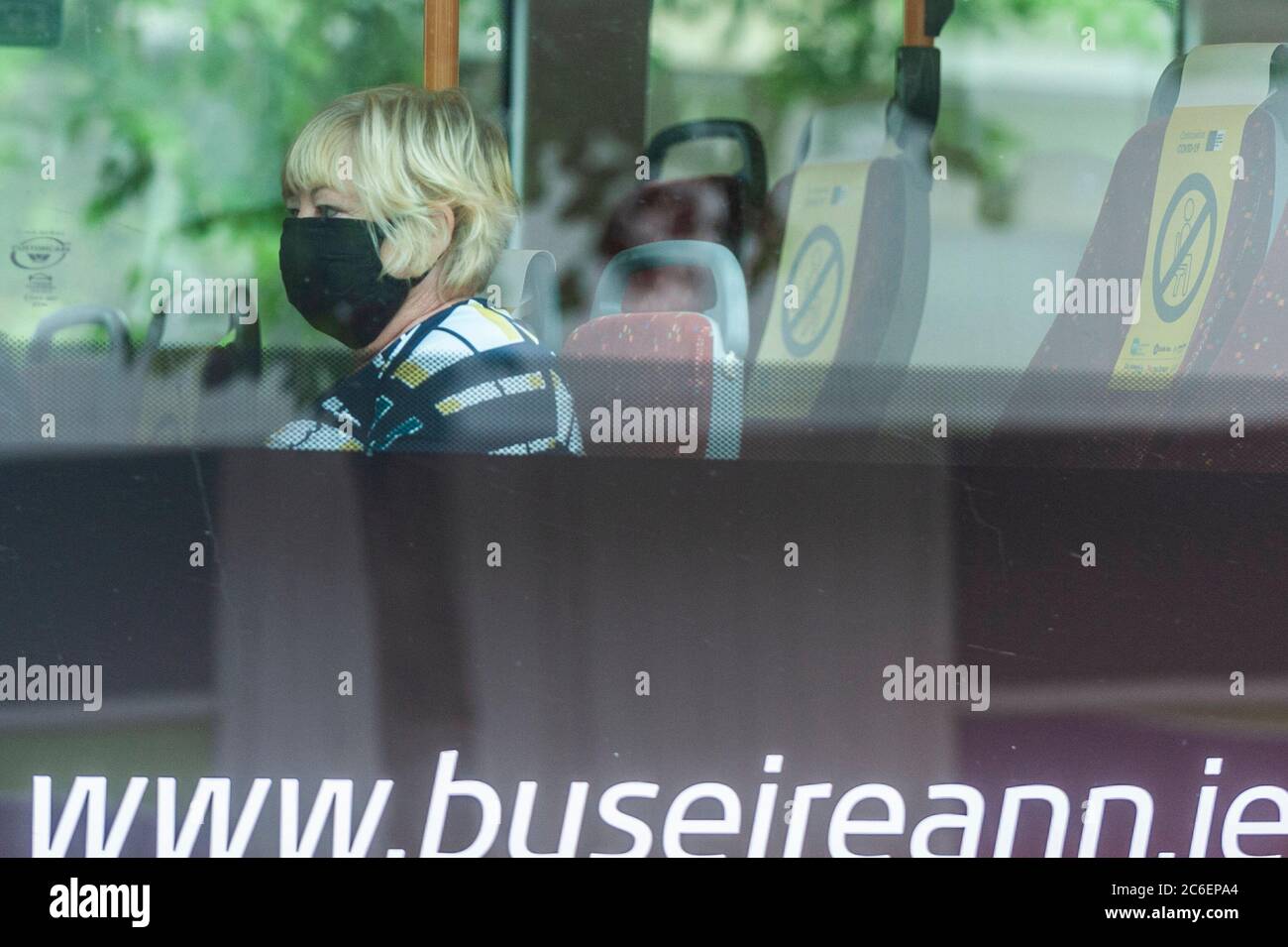 Cork, Ireland. 9th July, 2020. A woman wears a face mask on a Bus Eireann bus in Cork city today. The wearing of face masks on public transport became mandatory in Ireland on Monday 29th June. Credit: AG News/Alamy Live News Stock Photo