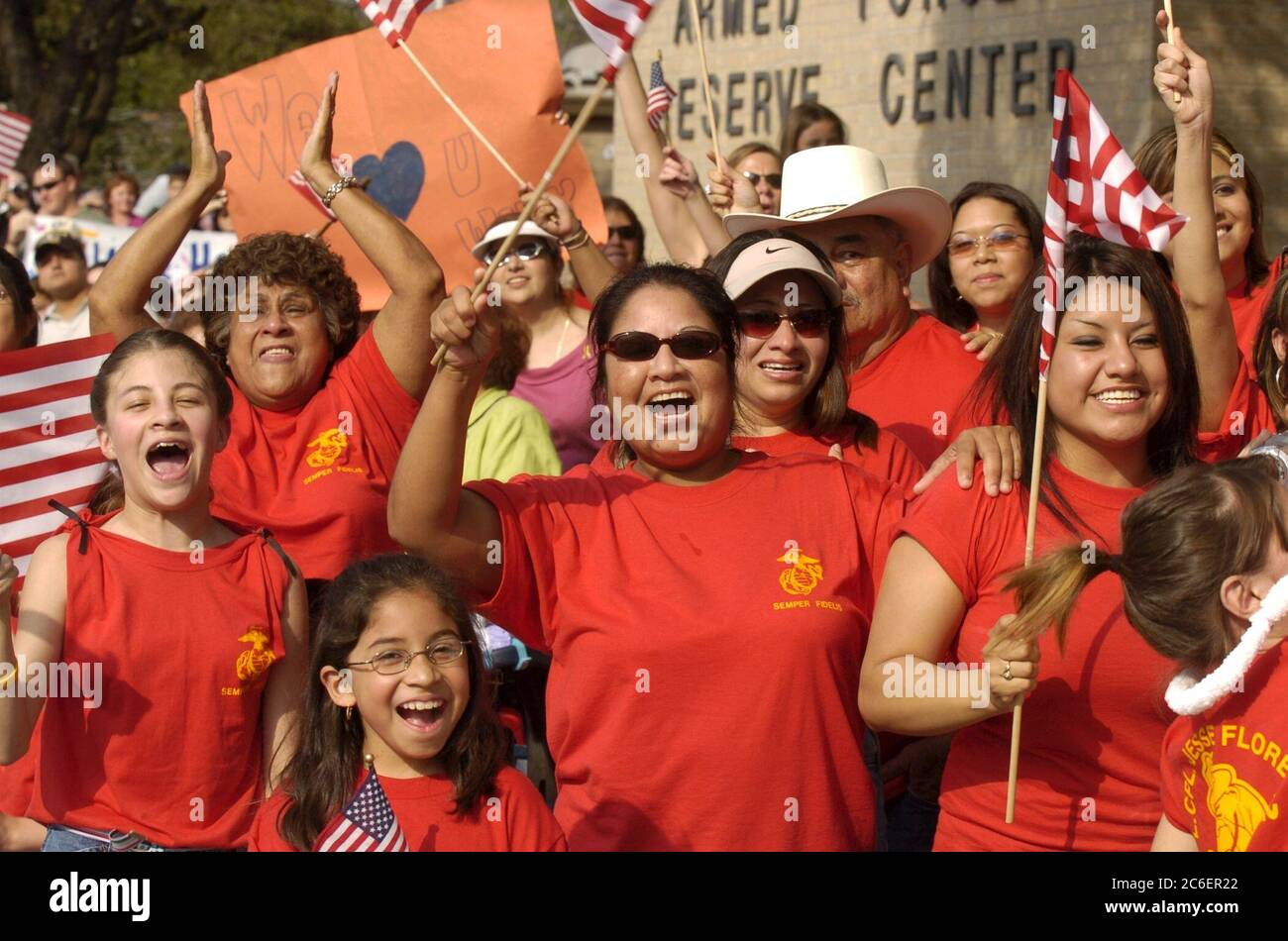 Austin, Texas USA, March 31, 2005: Excited family members wave American flags during a homecoming celebration for the 123rd Weapons Company, United States Marine Reserve unit from Camp Mabry, Texas.  ©Bob Daemmrich Stock Photo