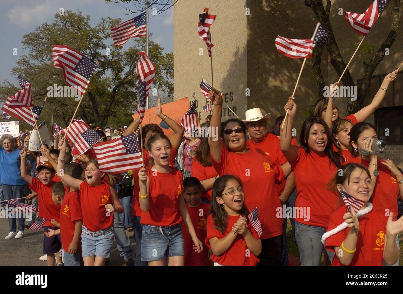 Austin, Texas USA, March 31, 2005: Excited family members wave American flags during a homecoming celebration for the 123rd Weapons Company, United States Marine Reserve unit from Camp Mabry, Texas.  ©Bob Daemmrich Stock Photo