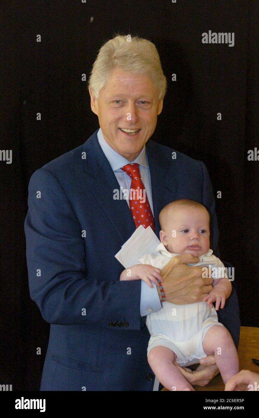 Austin, Texas USA, May 5 2005: Former U.S. President Bill Clinton poses for  a photo with a fan's infant as he signs copies of his memoir, "My Life," at  an independent bookstore