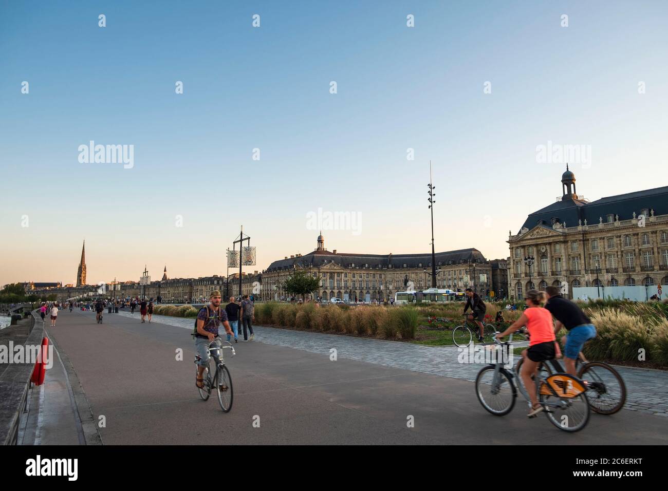Promenade along the Garrone River with walkers and cyclist at sunset, Bordeaux City, France Stock Photo