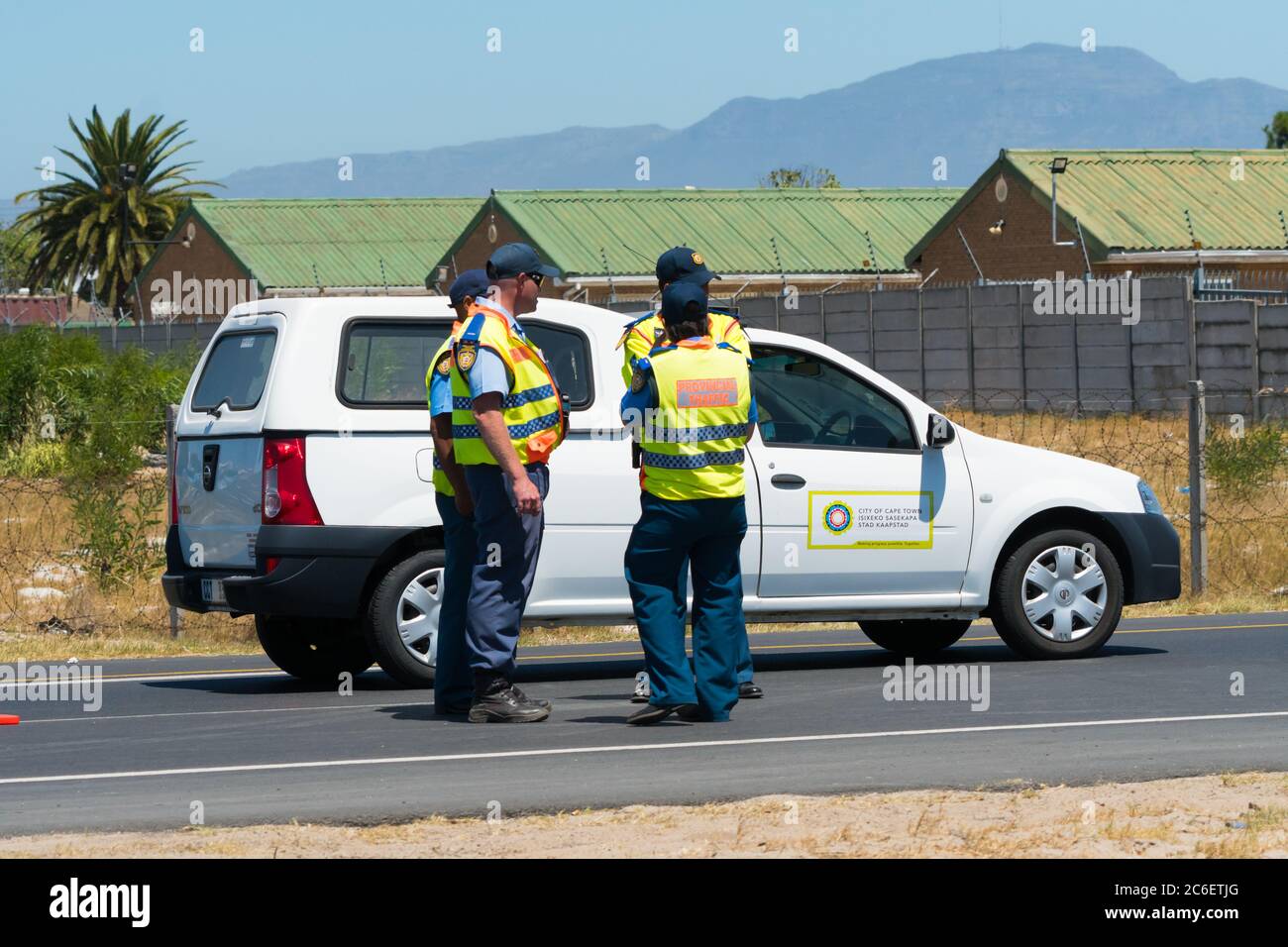 City of Cape Town traffic cops or officials on duty with a patrol van or car on the side of the road in Cape Town, South Africa Stock Photo