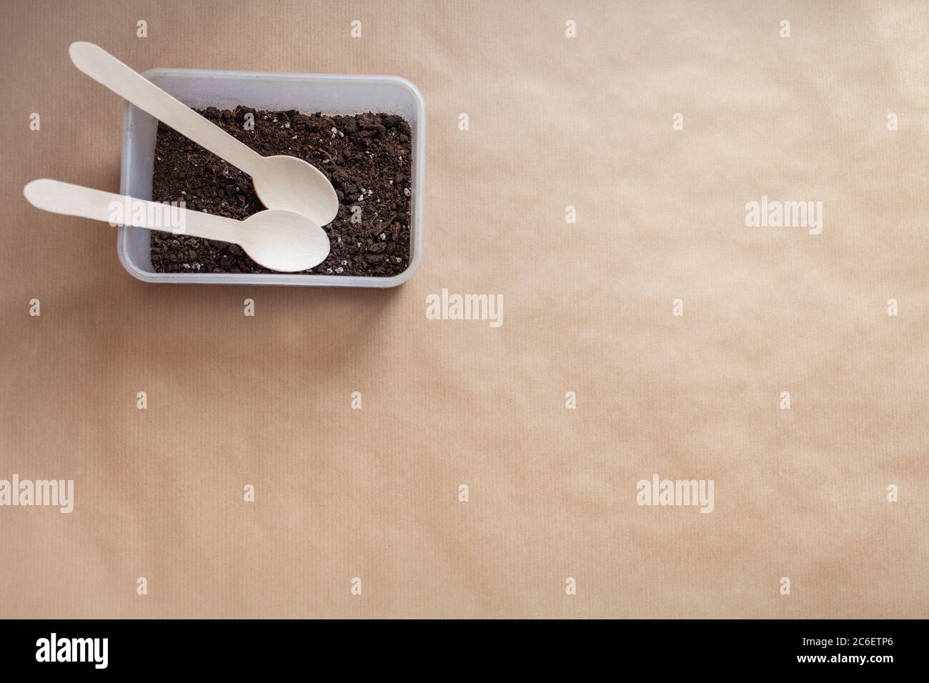 Wooden spoons in the earth, ecology versus plastic. Eco