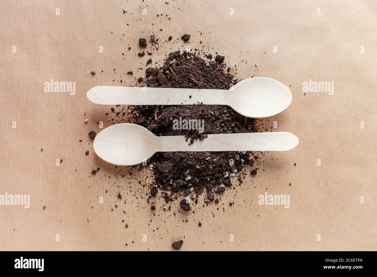Wooden spoons in the earth, ecology versus plastic. Eco