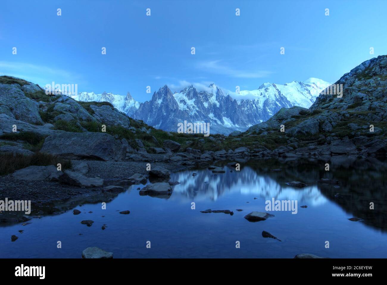Long exposure of Mont Blanc Massif reflecting in the small Lake Flegere, above Chamonix, France after sunset, under the moonlight. Mont Blanc peak (48 Stock Photo