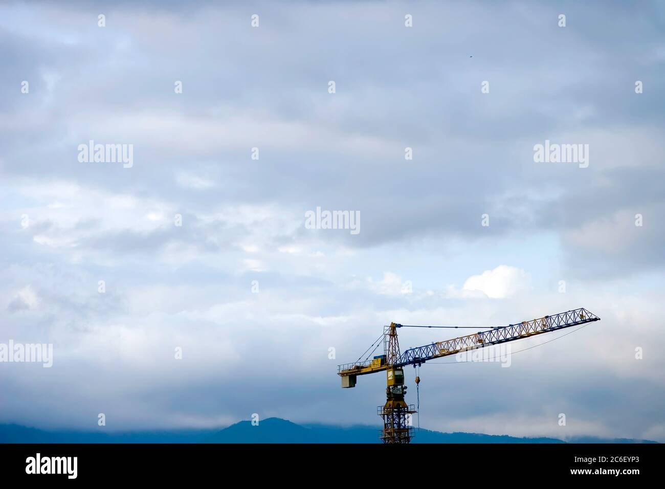Crane Construction site in front of the cloudy sky Stock Photo - Alamy