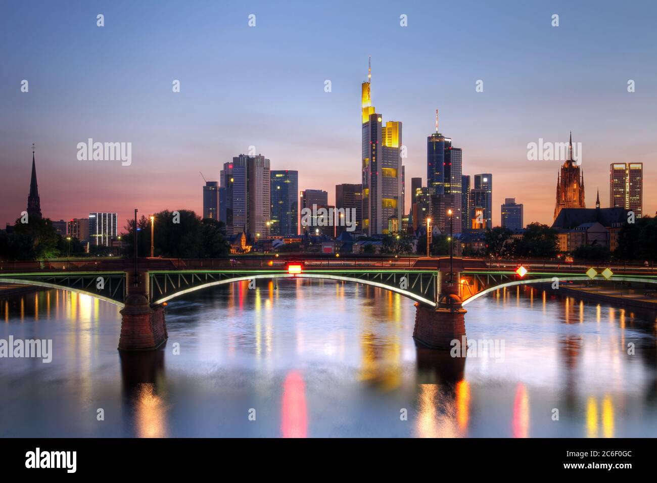 River view at twilight of Frankfurt am Main in Germany (Hesse). Most iconic buildings (skyscrapers) are visible, together with the tower of Saint Bart Stock Photo