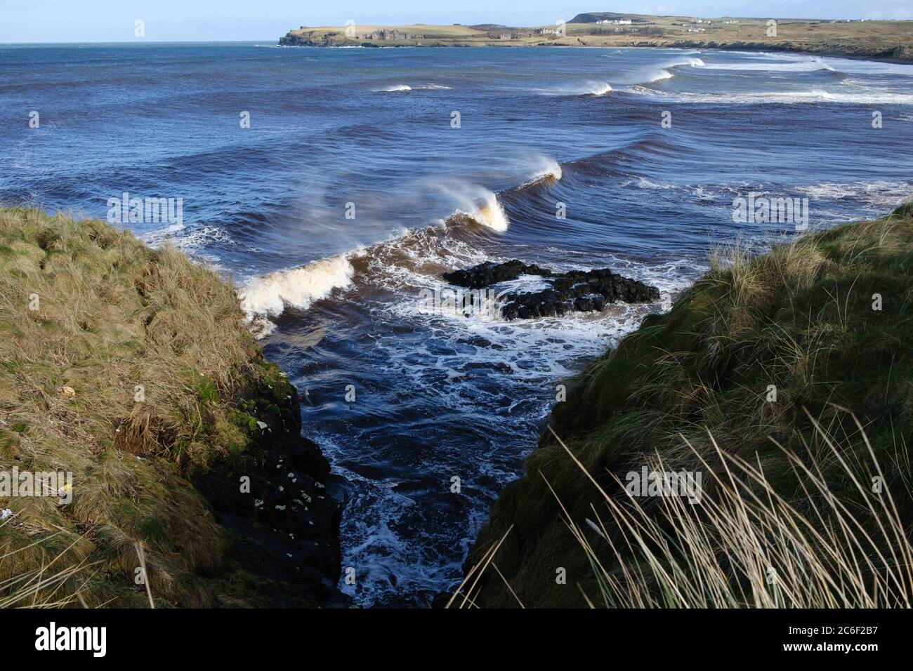 Rolling waves powering towards Runkerry beach near Portballintrae, County Antrim, Northern Ireland Stock Photo