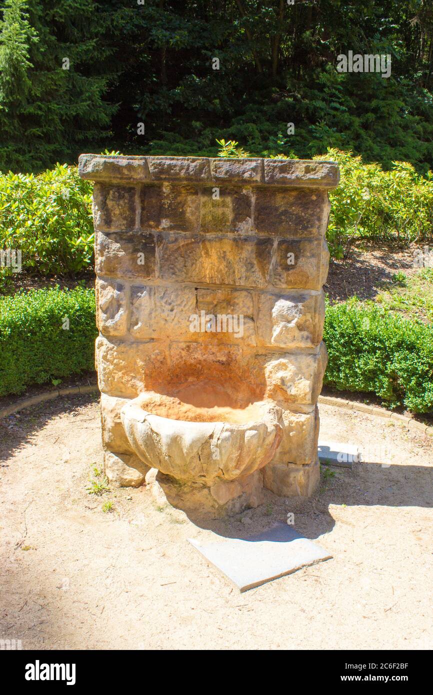 Stone reservoir with a spout for mineral water in the spa - a dry spring Stock Photo