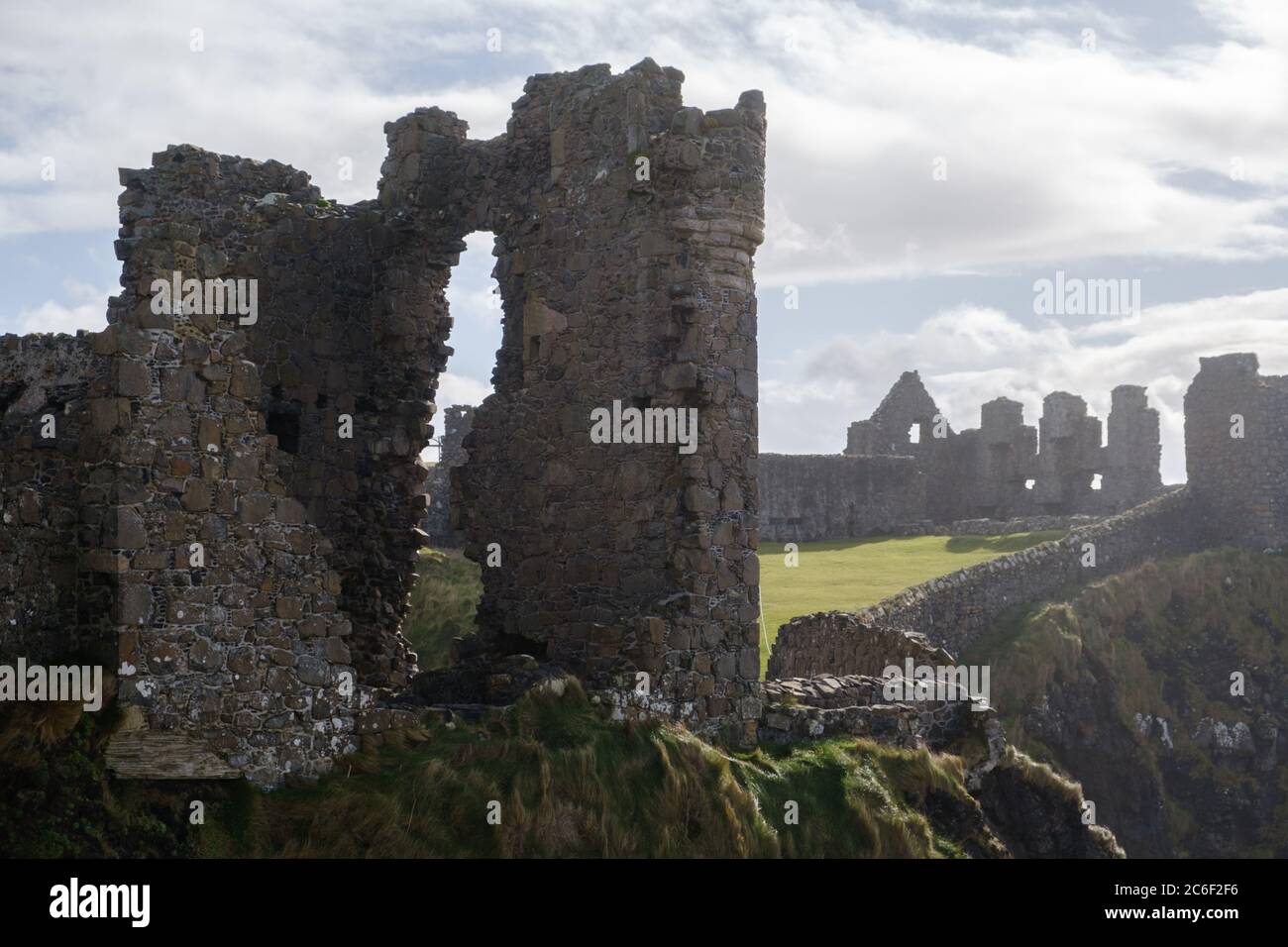 Mystical, ethereal view of the ruins of Dunluce Castle a filming location for the TV series Game of Thrones near Portrush in Northern Ireland Stock Photo