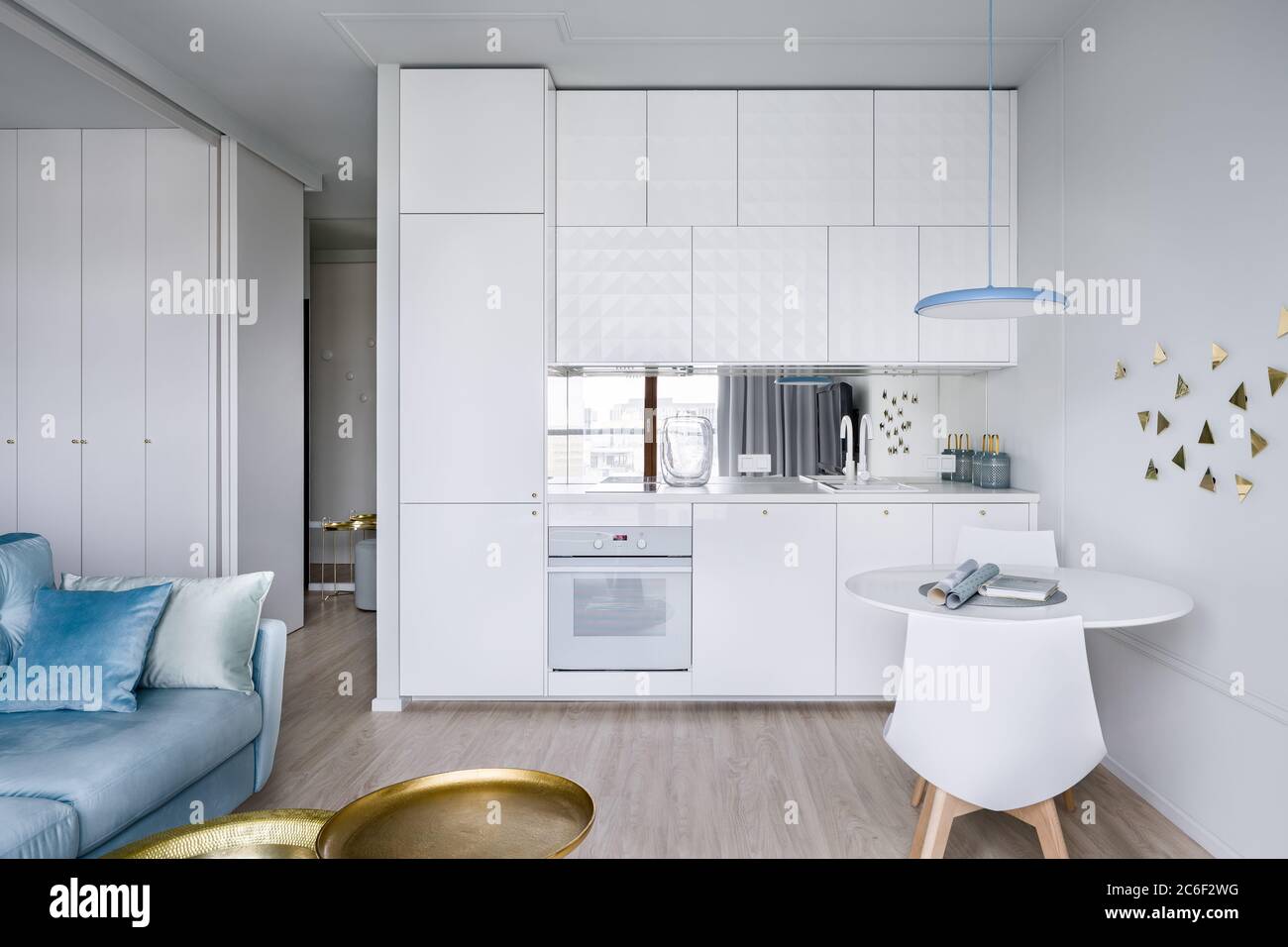 Contemporary apartment interior with small modern and white kitchenette Stock Photo