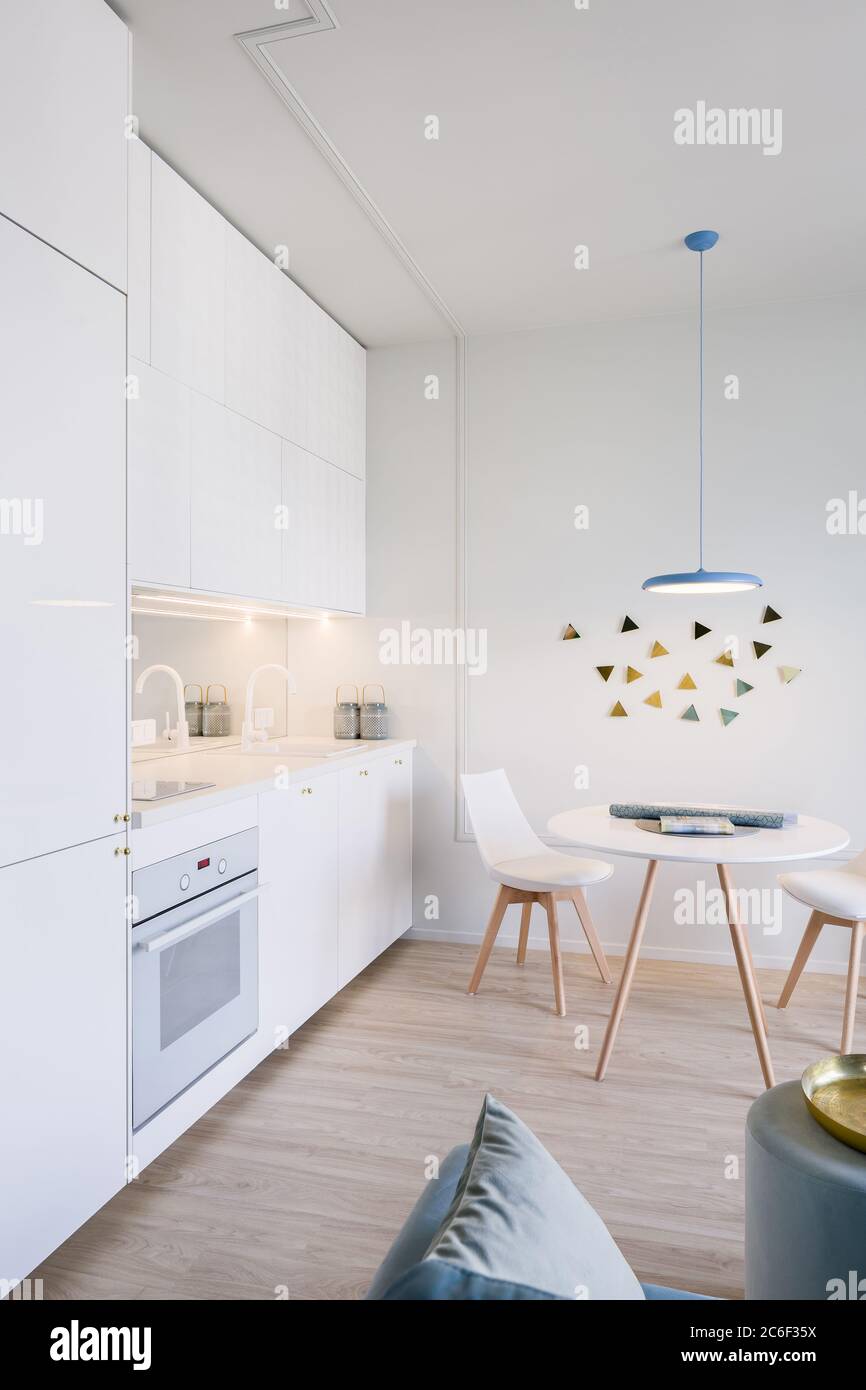 Modern home interior with open kitchen and round dining table Stock ...