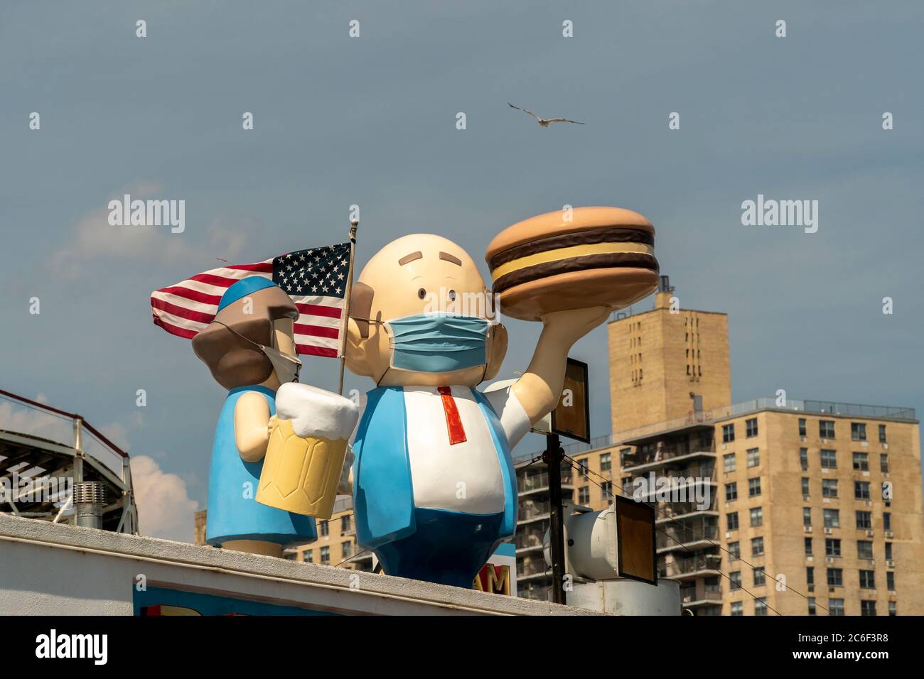 Paul’s Daughter restaurant puts masks on their figures on the boardwalk at Coney Island in