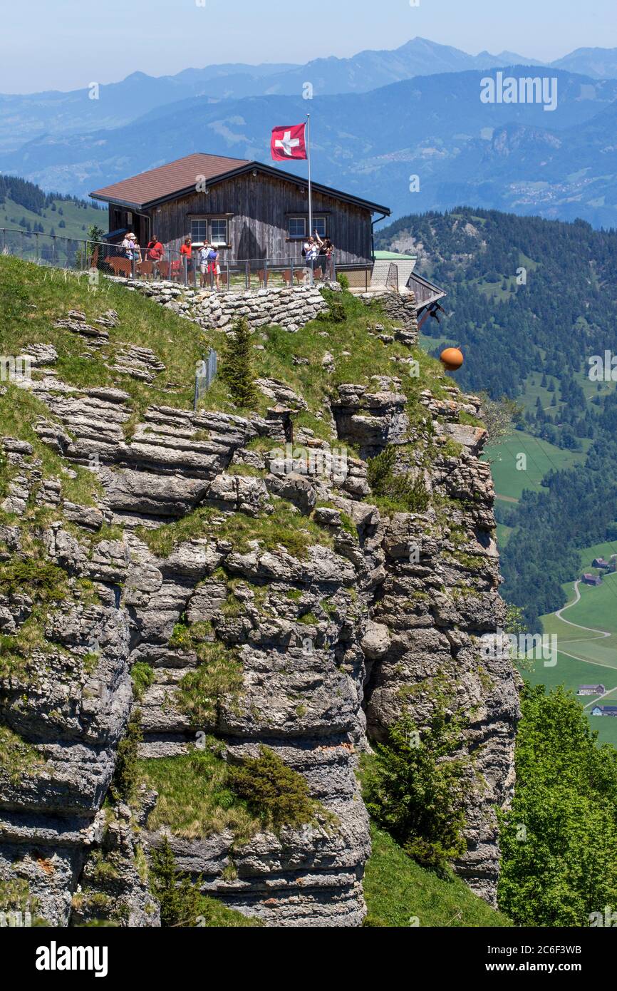 EBENALP, SWITZERLAND, 11 JUNE 2017: Viewpoint with hikers at the Inn Berggasthaus on the top of Ebenalp rock. Ebenalp is an attractive recreation regi Stock Photo