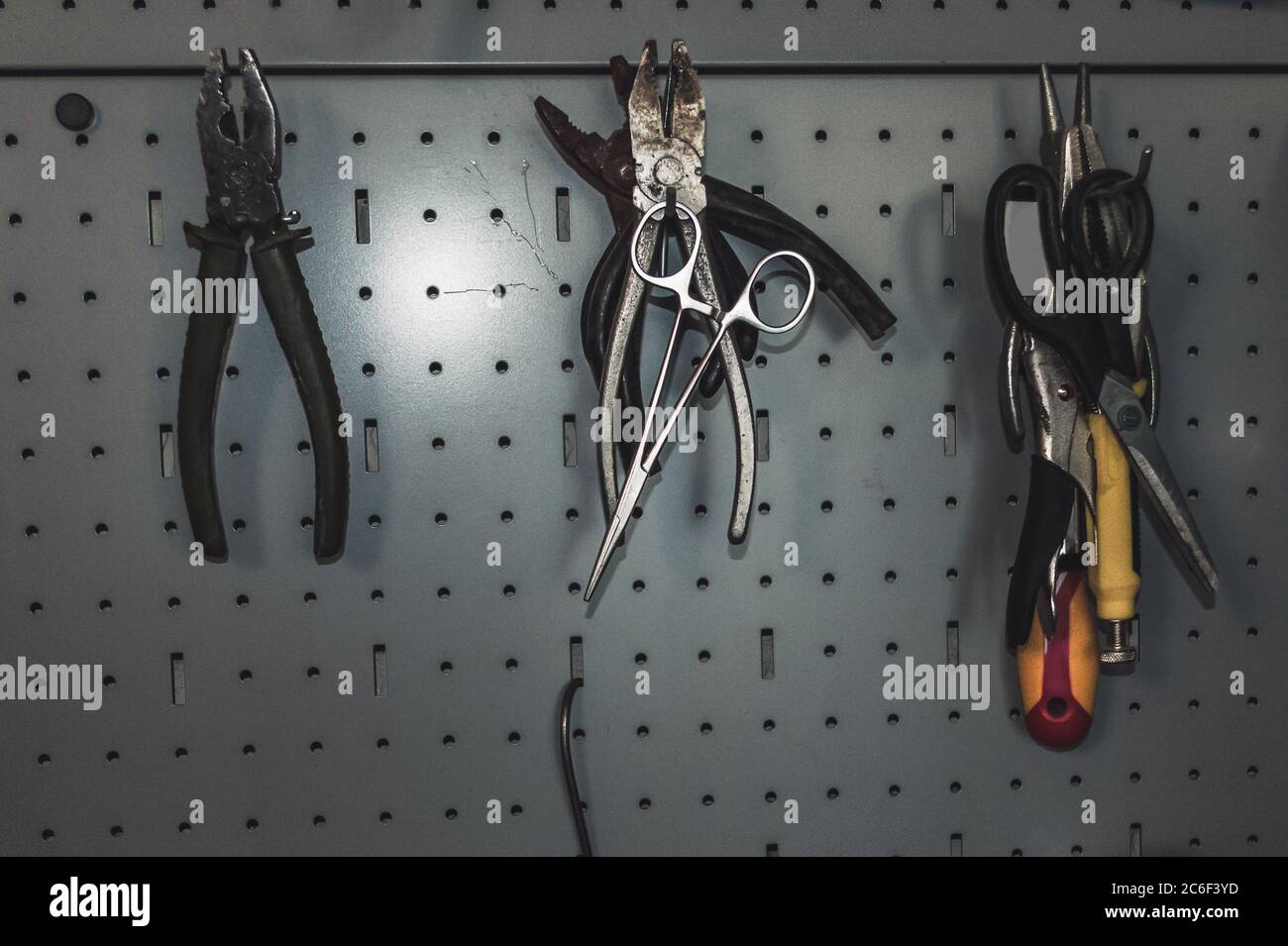 view of iron board with hooks and hanging on them tools wire cutters