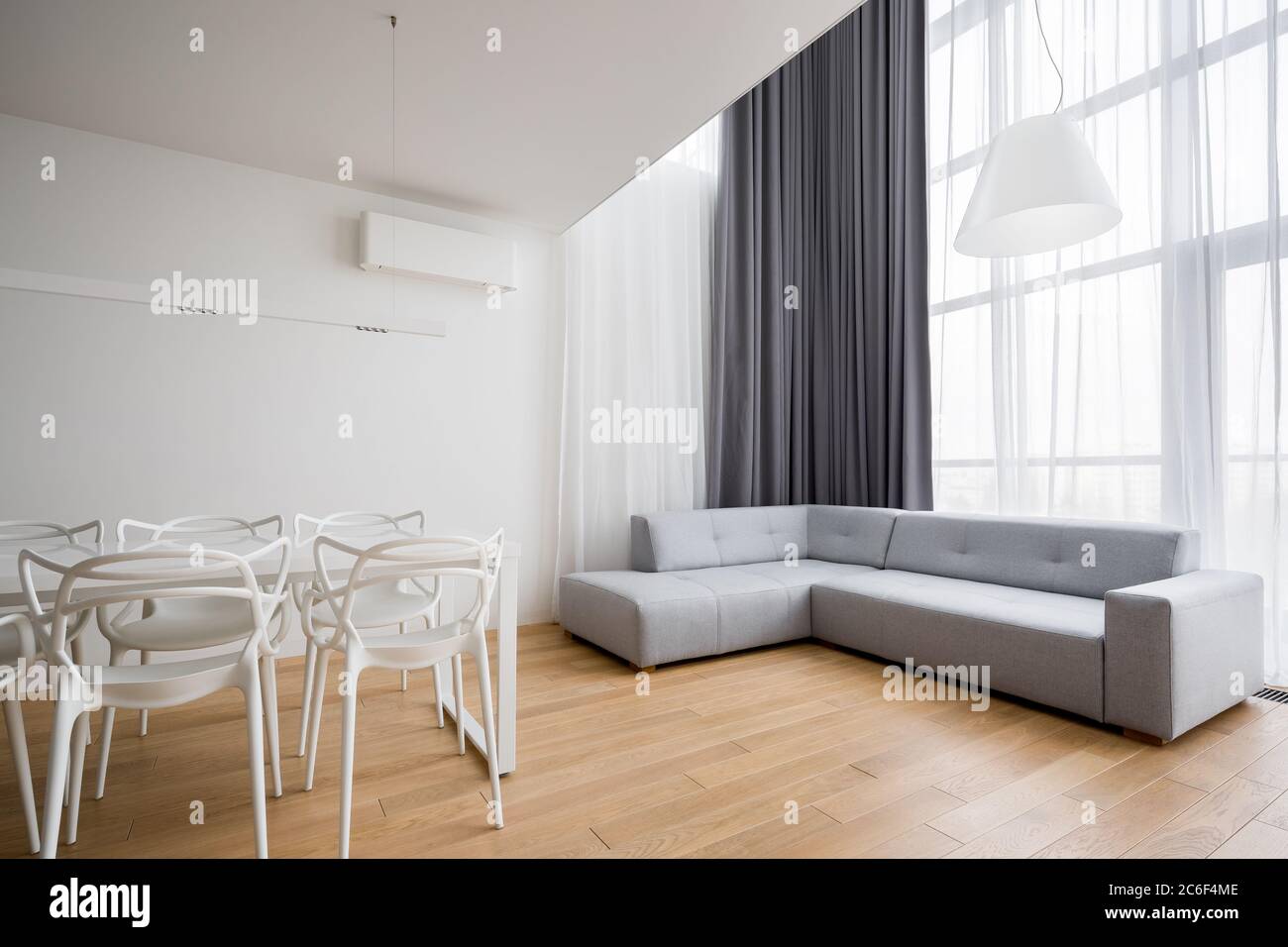 Home interior with corner sofa and new design white chairs Stock Photo