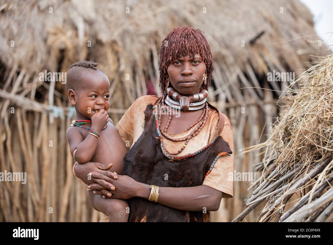 Black woman with child of the Hamar / Hamer tribe in village in the Omo ...