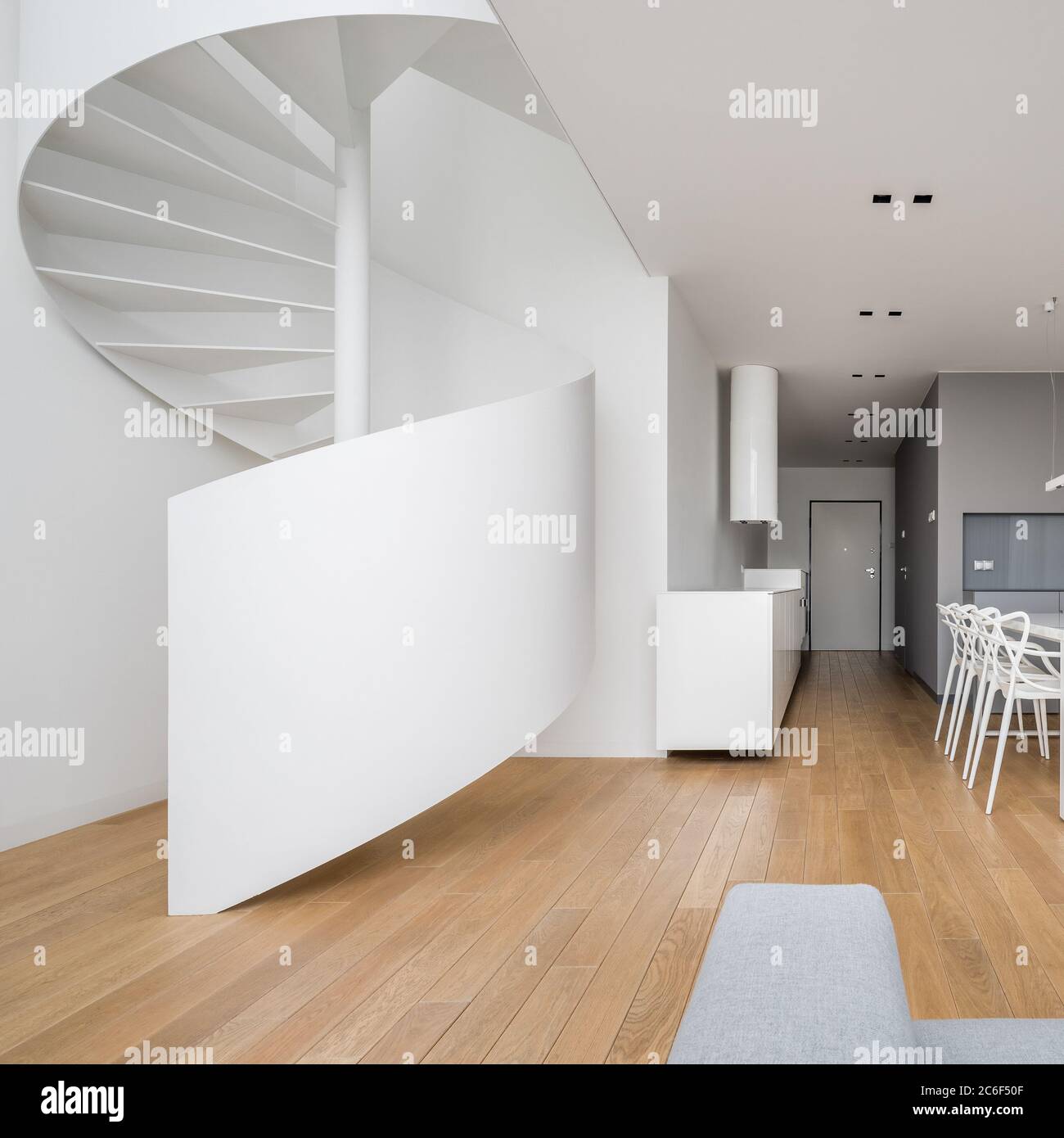 New design two-storey apartment in white with spiral staircase Stock Photo