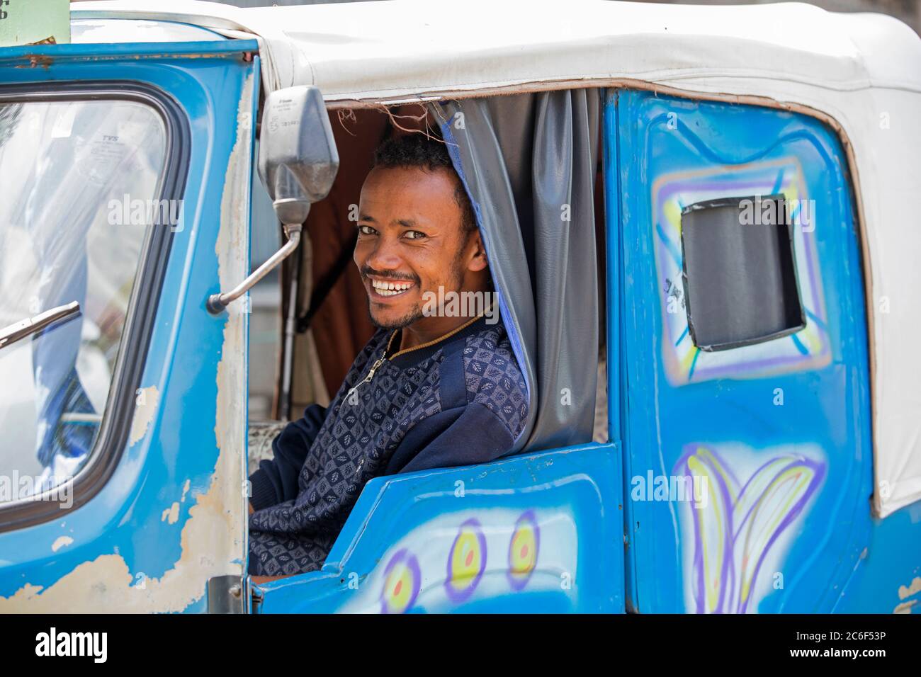 Black taxi driver smiling in tuk-tuk / auto rickshaw in the city Awasa / Awassa / Hawassa, Great Rift Valley, Southern Ethiopia, Africa Stock Photo