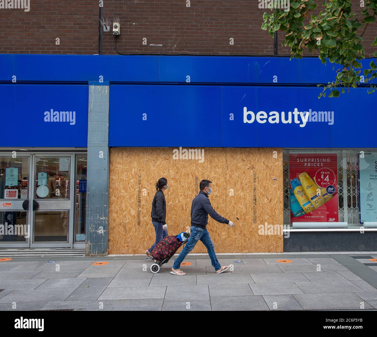 Slough, Berkshire, UK. 9th July, 2020. A man and a woman wearing face