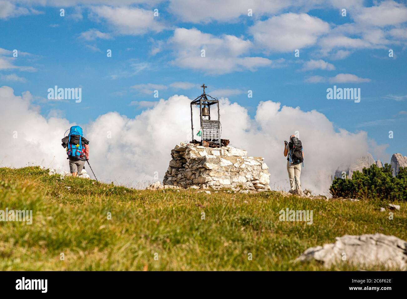 Italy South Tyrol  Alta Pusteria Dobbiaco Monte Piana -  Hikers near the Peace Bell on Monte Piana Stock Photo
