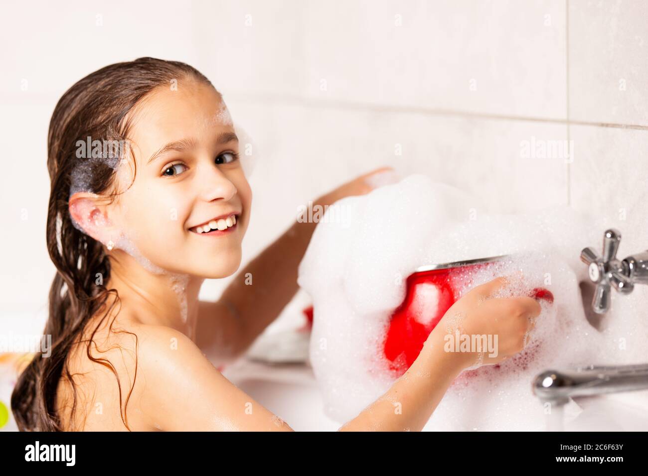 Young lass having fun in the bath