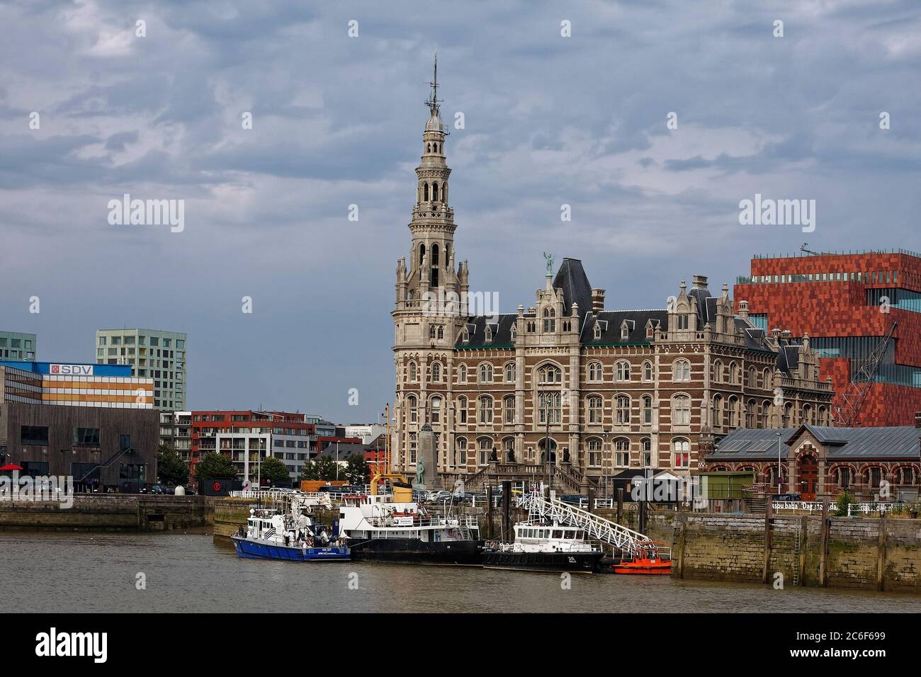 Pilotage Authority Building; 1894; ornate, old, spire, many windows, boats, maritime scene, River Scheldt, water, Flanders; Europe; Antwerp; Belgium Stock Photo