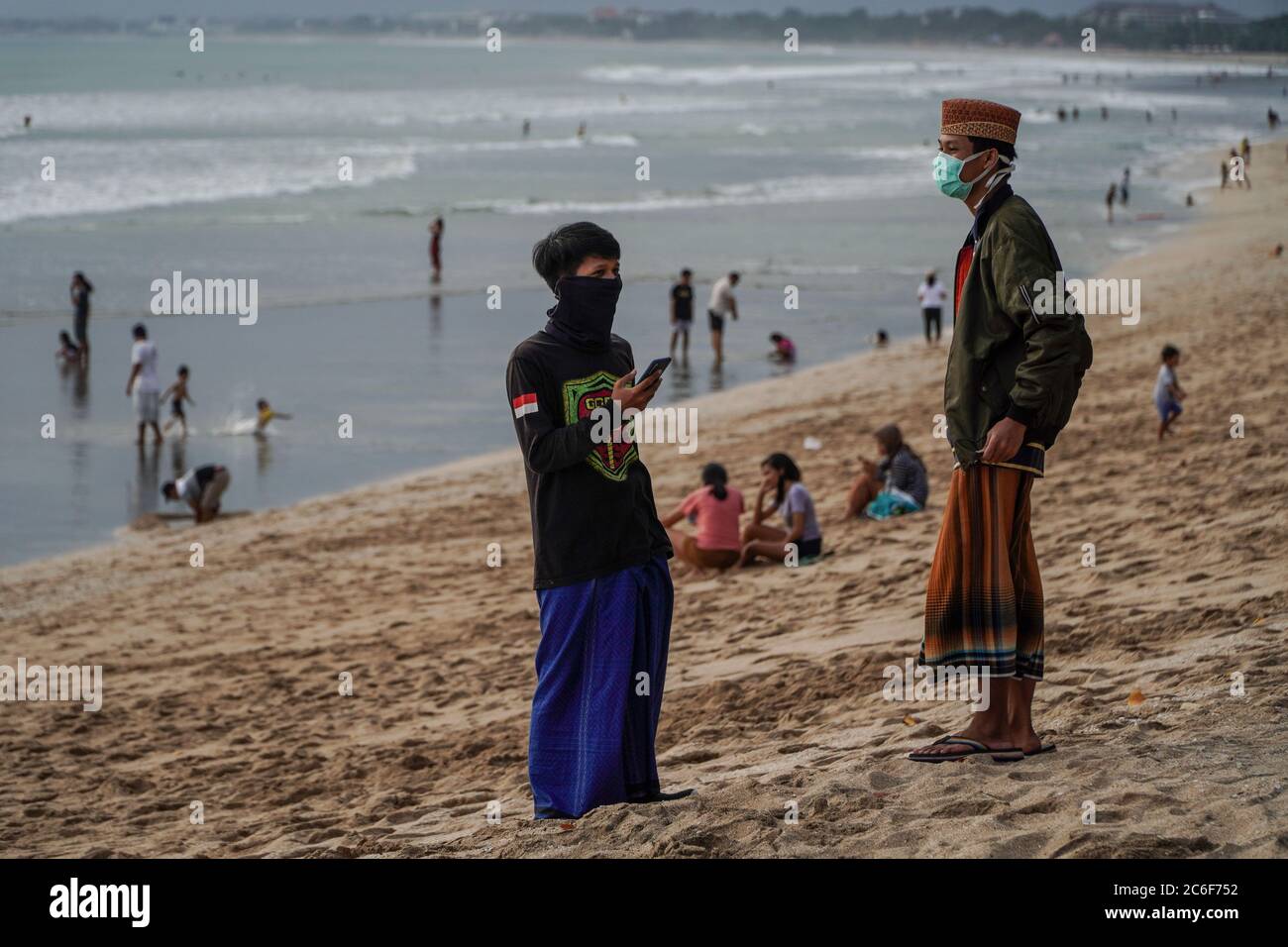 Badung, Bali, Indonesia. 9th July, 2020. People flocks in Kuta Beach await  for sunset time. Local government start to reopen famous tourism icon of  Kuta Beach for Bali citizens as a stage