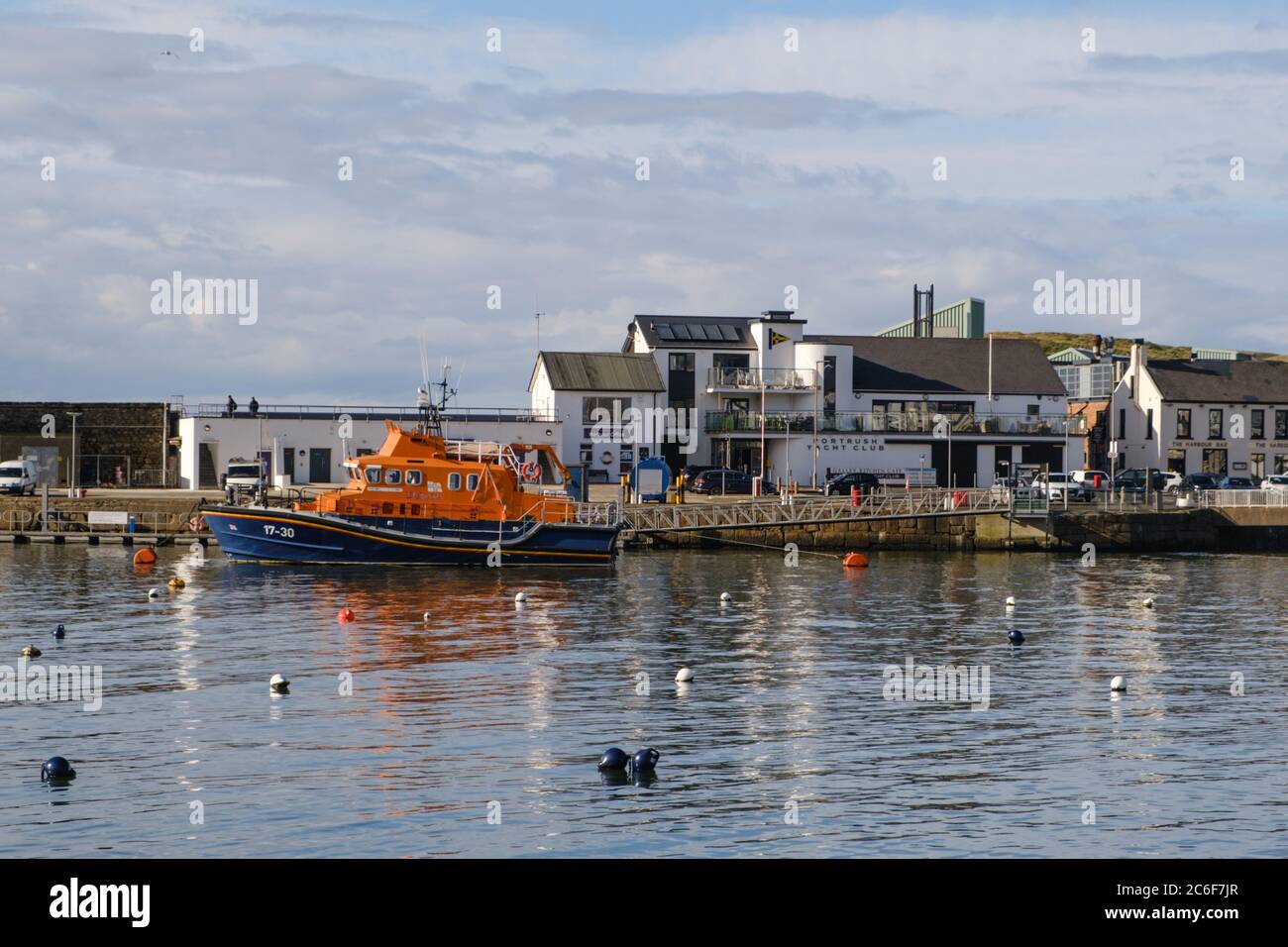 RNLI Lifeboat in Portrush Harbour. In background, Portrush Yacht Club. Stock Photo