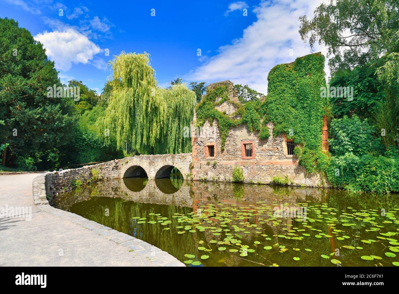 Old ruin called 'Kirchenruine zum heiligen Grab' in front of pond in public park called 'Schöntal' in center of German city Aschaffenburg Stock Photo