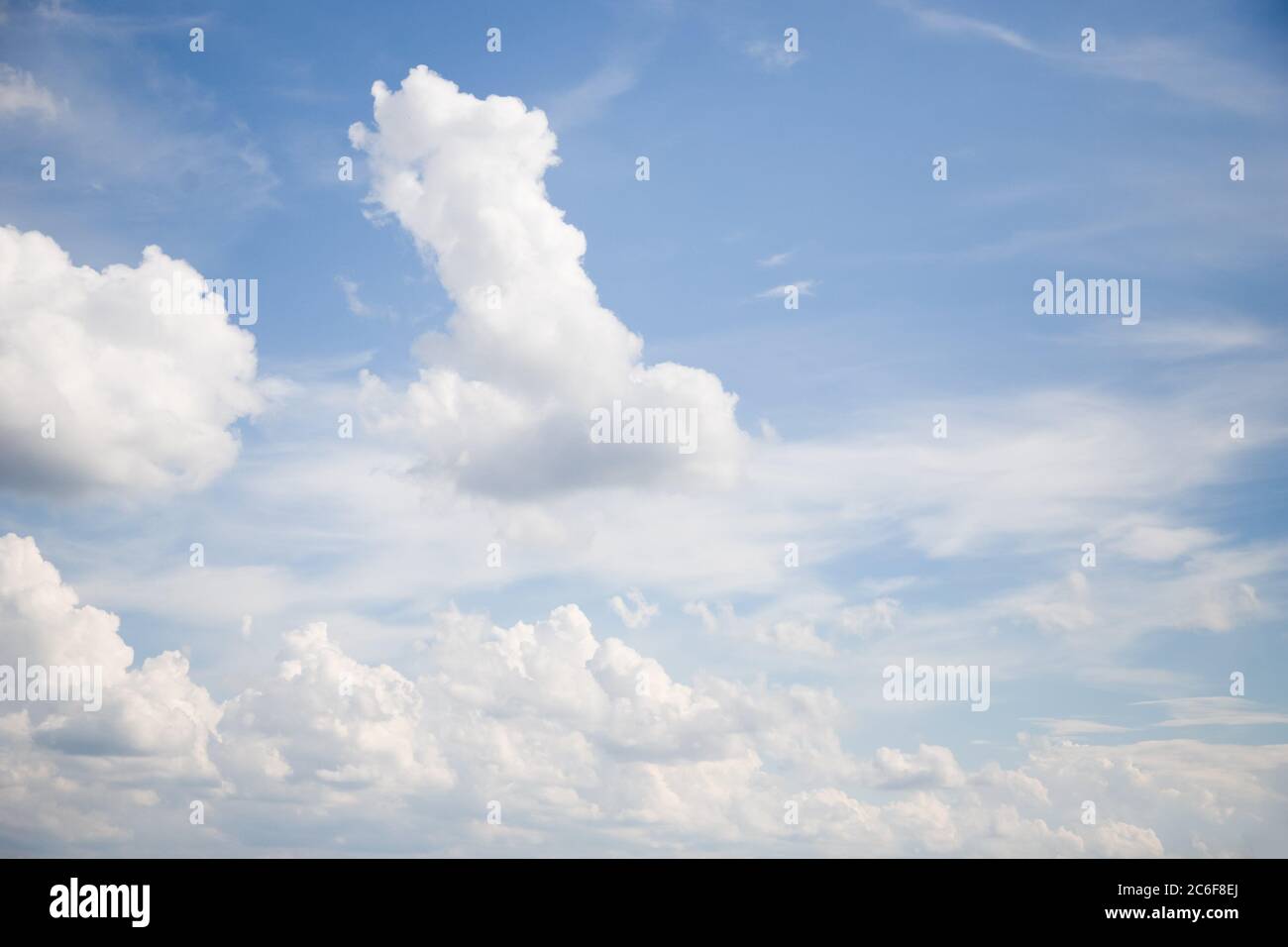 White clouds float across the light blue sky Stock Photo