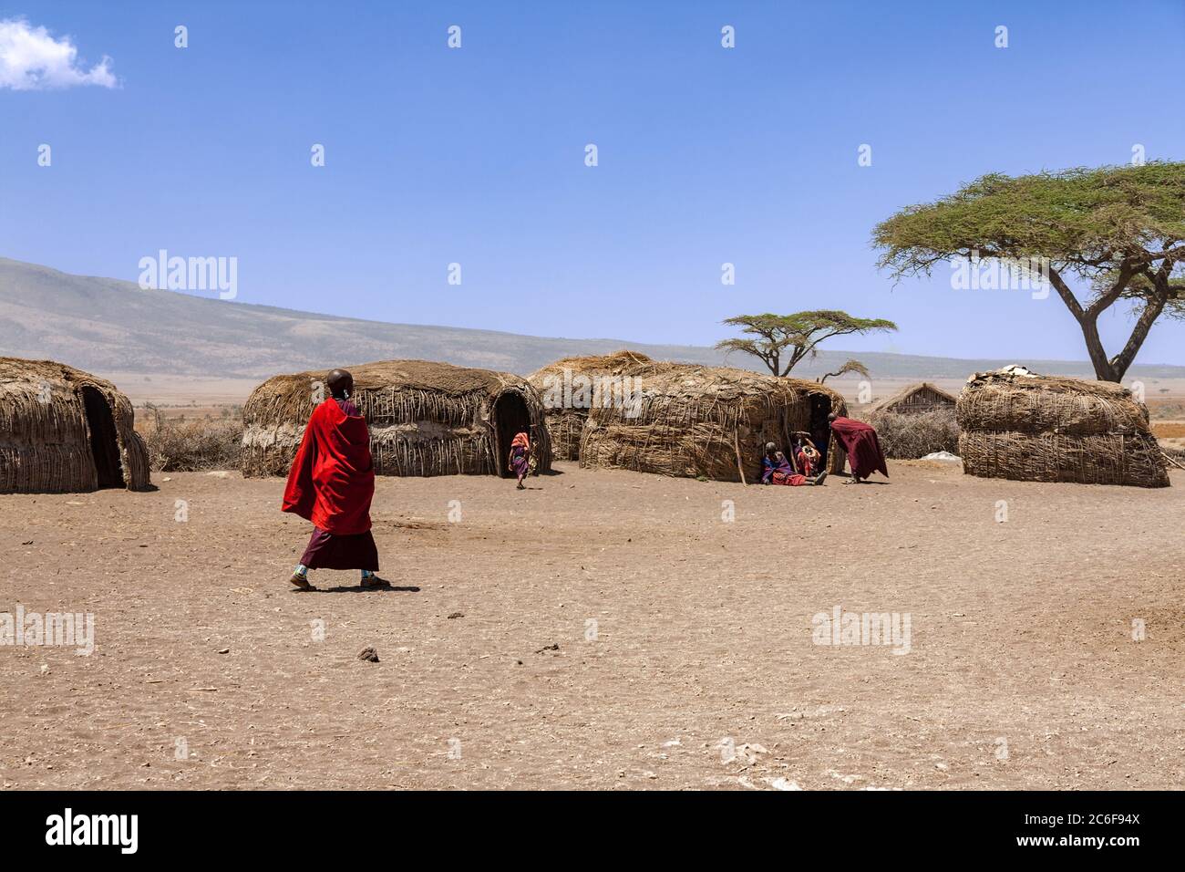 Serengeti, Tanzania - September 21. 2012: Massai villagers with their daily life inside an Massai village with traditional huts in the Serengeti Natio Stock Photo