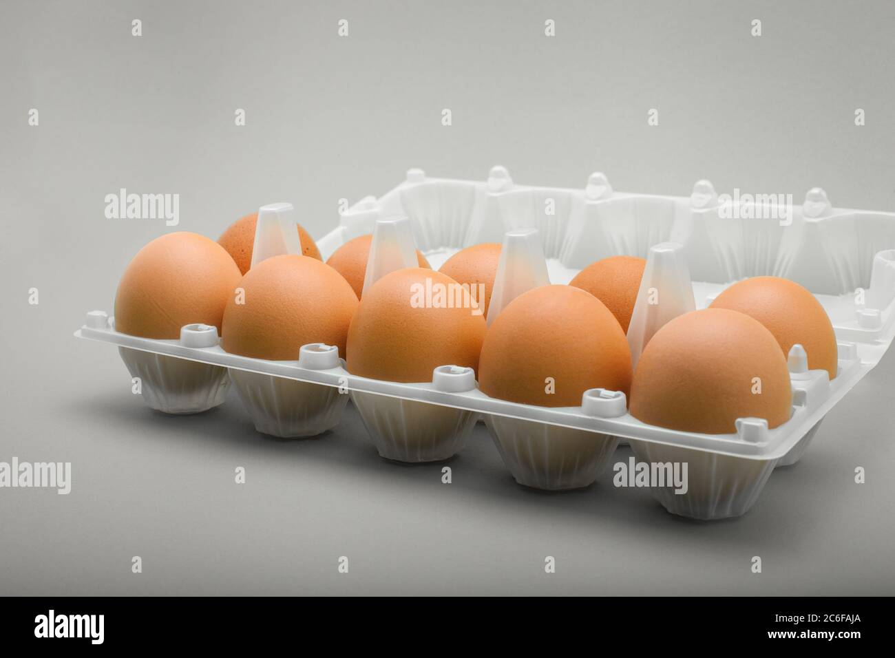 Eggs in a plastic tray, 10 pieces of brown chicken eggs. Stock Photo